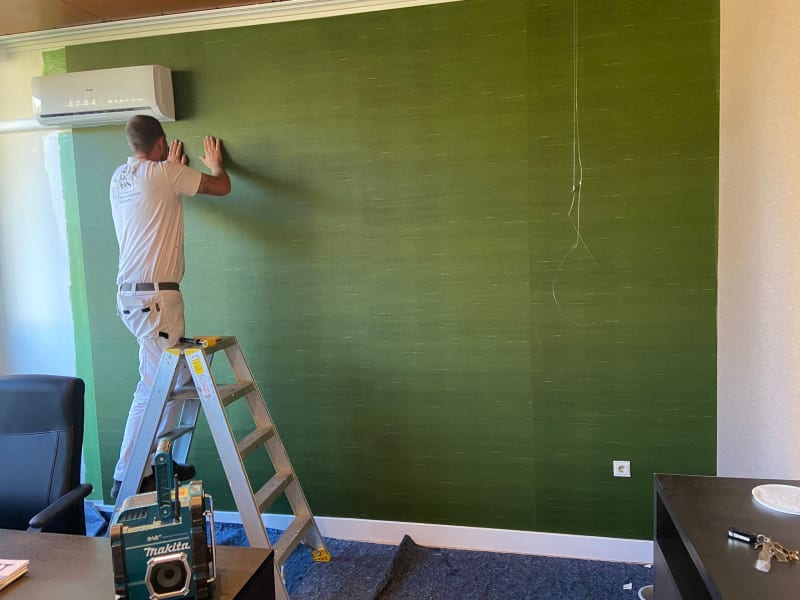 Green wallpaper being installed by our professionals